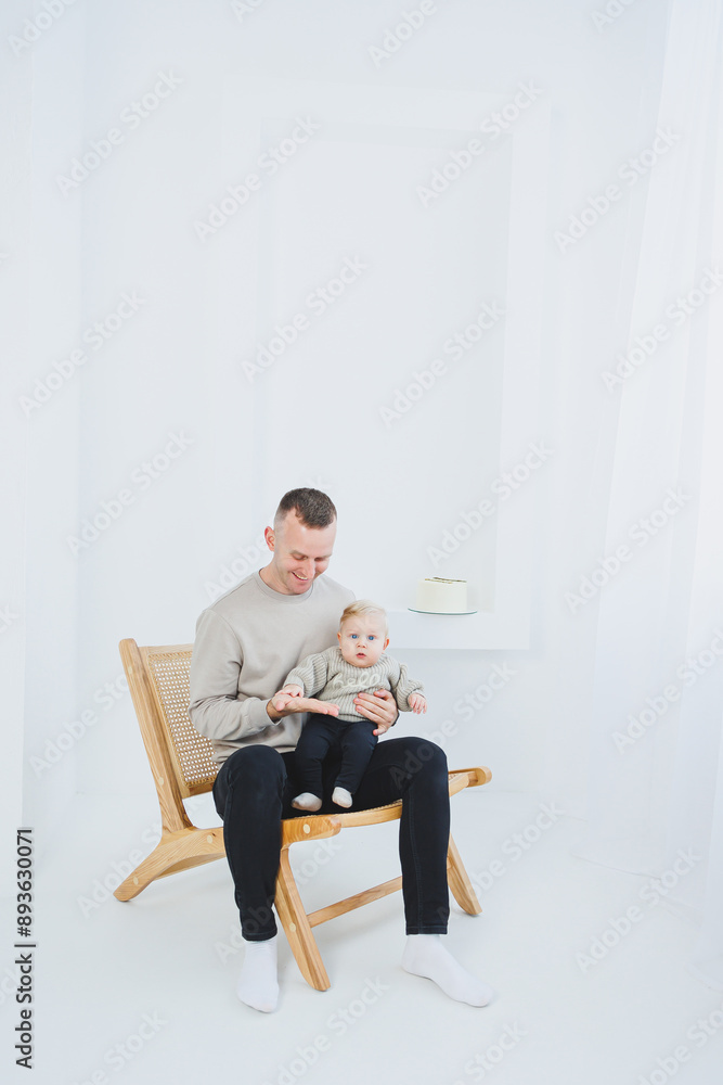 Young dad hugs his newborn son. Dad and little baby in hands. Happy dad with a child. Young dad hugs his newborn son. Dad and little baby in hands. Happy dad with a child.