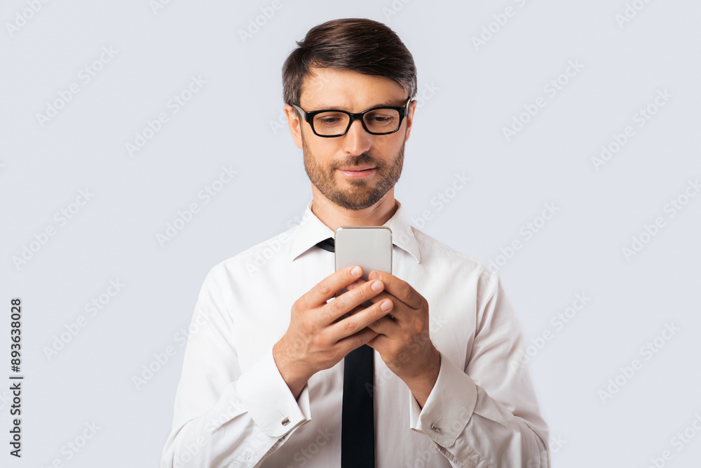 Business App. Serious Businessman Using Smartphone Standing Over White Studio Background. Copy Space Business App. Serious Businessman Using Smartphone Standing Over White Studio Background. Copy Space