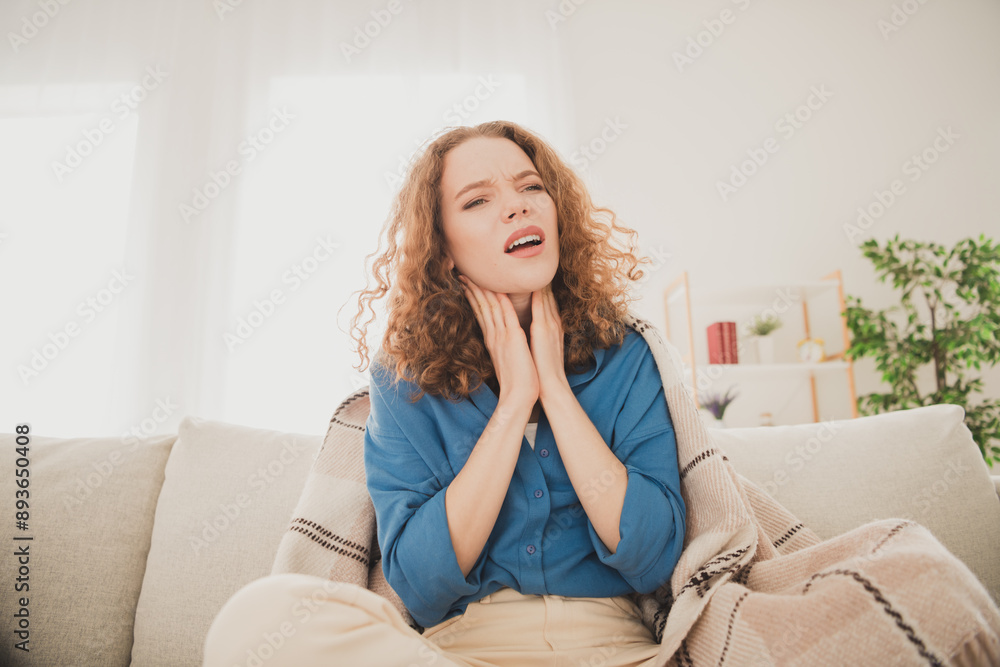 Photo of cheerful young female sore throat touch neck suffer blue shirt weekend apartment indoors inside house home Photo of cheerful young female sore throat touch neck suffer blue shirt weekend apartment indoors inside house home