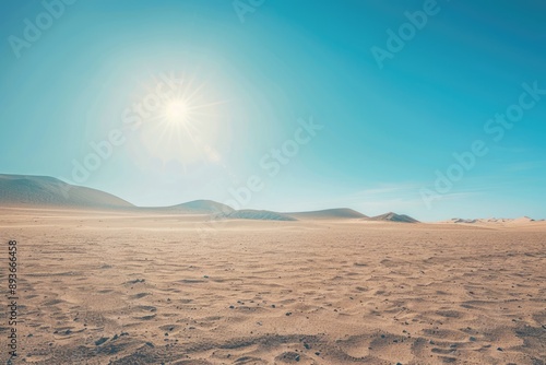Blazing sun over endless desert, dunes under blue sky