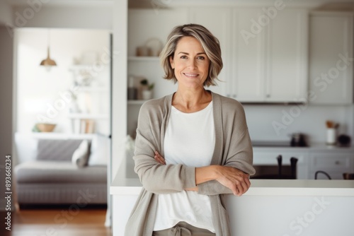 Portrait of a satisfied woman in her 40s wearing a chic cardigan over modern minimalist interior