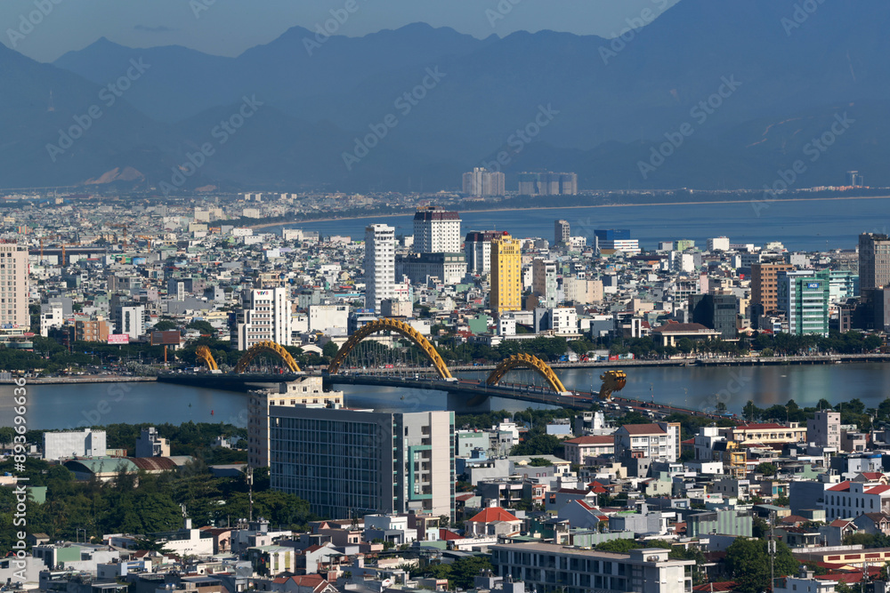 Obraz premium far view of dragon bridge in da nang. This modern bridge crosses the Han River at the Le Dinh Duong, Bach Dang traffic circle