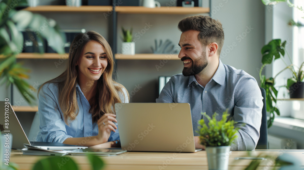 Portrait of success business people working together in home office. Couple teamwork startup concept. Happy colleagues or entrepreneurs team man and woman discussing corporate technology at workplace Portrait of success business people working together in home office. Couple teamwork startup concept. Happy colleagues or entrepreneurs team man and woman discussing corporate technology at workplace