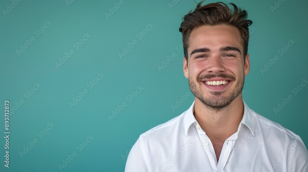 a portrait of a smiling young man in a white shirt on a teal background, conveying positivity and professionalism, with space allocated for adding text or branding a portrait of a smiling young man in a white shirt on a teal background, conveying positivity and professionalism, with space allocated for adding text or branding