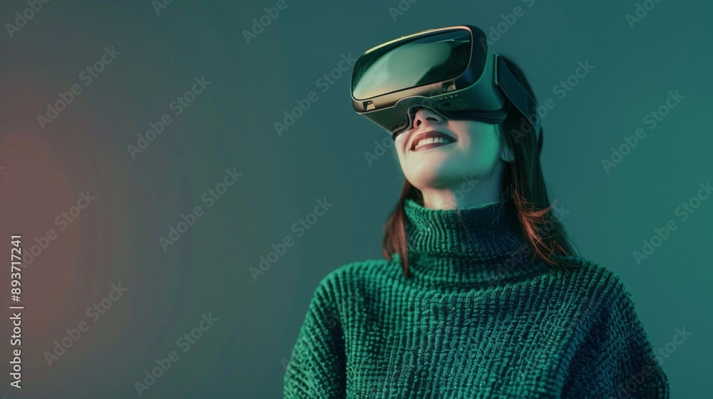 Smiling businesswoman in green sweater is wearing vr helmet. Digital interface in 3d glasses. Concept of future technology, interaction and entertainment playing game in virtual reality Smiling businesswoman in green sweater is wearing vr helmet. Digital interface in 3d glasses. Concept of future technology, interaction and entertainment playing game in virtual reality