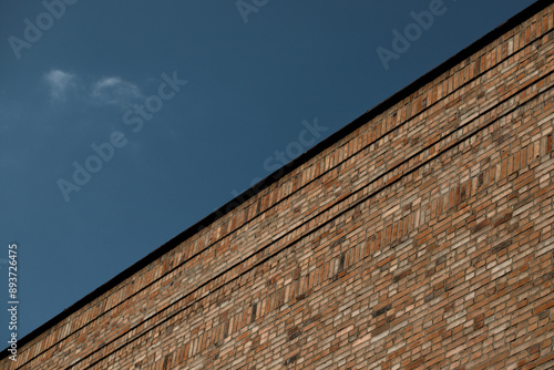 Half blue sky half brick wall background