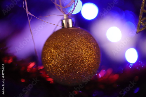 A closeup of a glitter christmas bauble