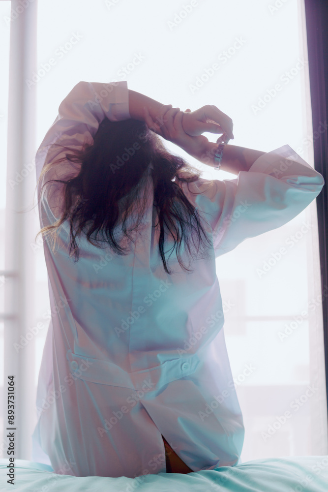 young woman wakes up in morning alone and prepares to go to work. young woman prepares to put on her clothes after waking up in morning to prepare to go on an excursion according to program. young woman wakes up in morning alone and prepares to go to work. young woman prepares to put on her clothes after waking up in morning to prepare to go on an excursion according to program.