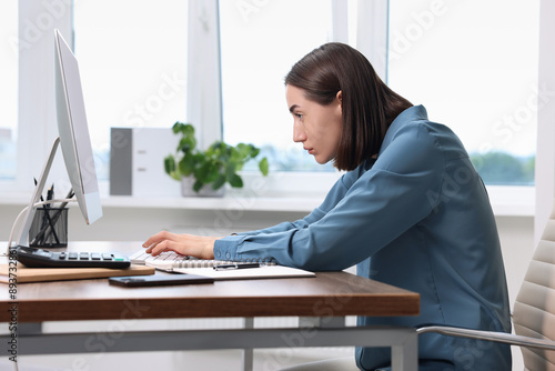 Konstfotografi Woman with poor posture working in office