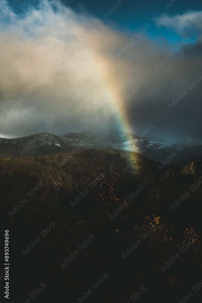 Rainbow emerging over snowy mountains Rainbow emerging over snowy mountains