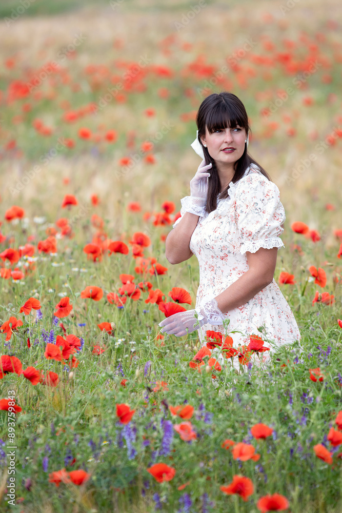 Young elegant lady standing in poppy field Young elegant lady standing in poppy field