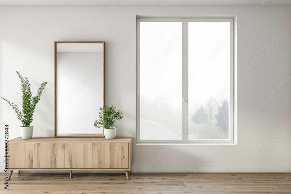 Fototapeta premium Stylish property interiors composition with a mirror next to a large window filling the room with natural lighting. Residential interiors design with minimal decor and warm colors.
