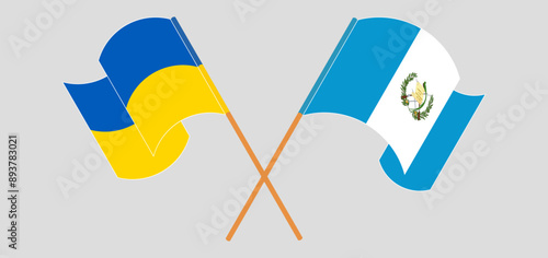 Crossed and waving flags of Ukraine and Republic of Guatemala