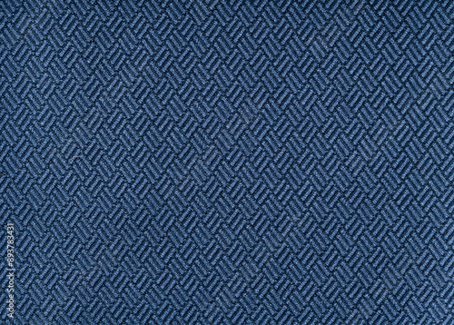 Close up photo of a woven blue background fabric with geometric pattern