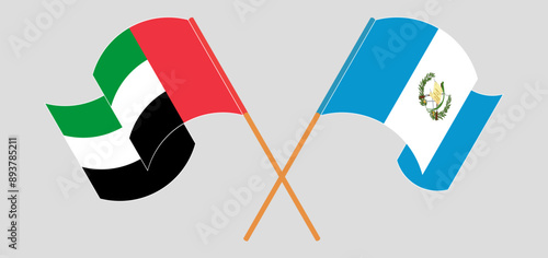 Crossed and waving flags of the United Arab Emirates and Republic of Guatemala