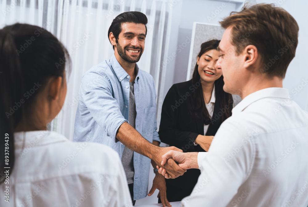 Diverse group of office employee worker shake hand after making agreement on strategic business marketing meeting. Teamwork and positive attitude create productive and supportive workplace. Prudent Diverse group of office employee worker shake hand after making agreement on strategic business marketing meeting. Teamwork and positive attitude create productive and supportive workplace. Prudent