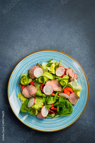 Salad with veal, spinach and radish. Close up.