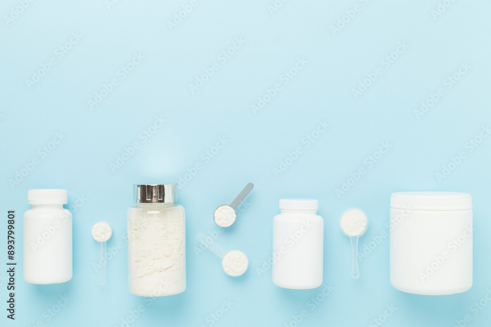 Jars with protein powder on color background, top view. Sports nutrition concept Jars with protein powder on color background, top view. Sports nutrition concept