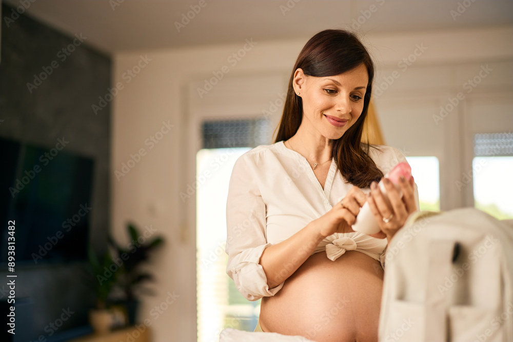 A soon-to-be mom, packing some stuff in the bag for the maternity hospital. A soon-to-be mom, packing some stuff in the bag for the maternity hospital.