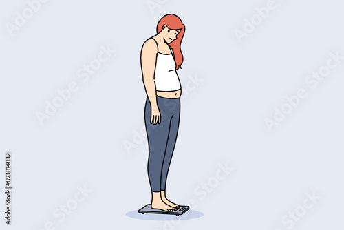 Problem of obesity and weight gain about depressed woman standing on electronic floor scale. Girl became obese due to poor diet or problems with metabolism that prevented absorption of foods.