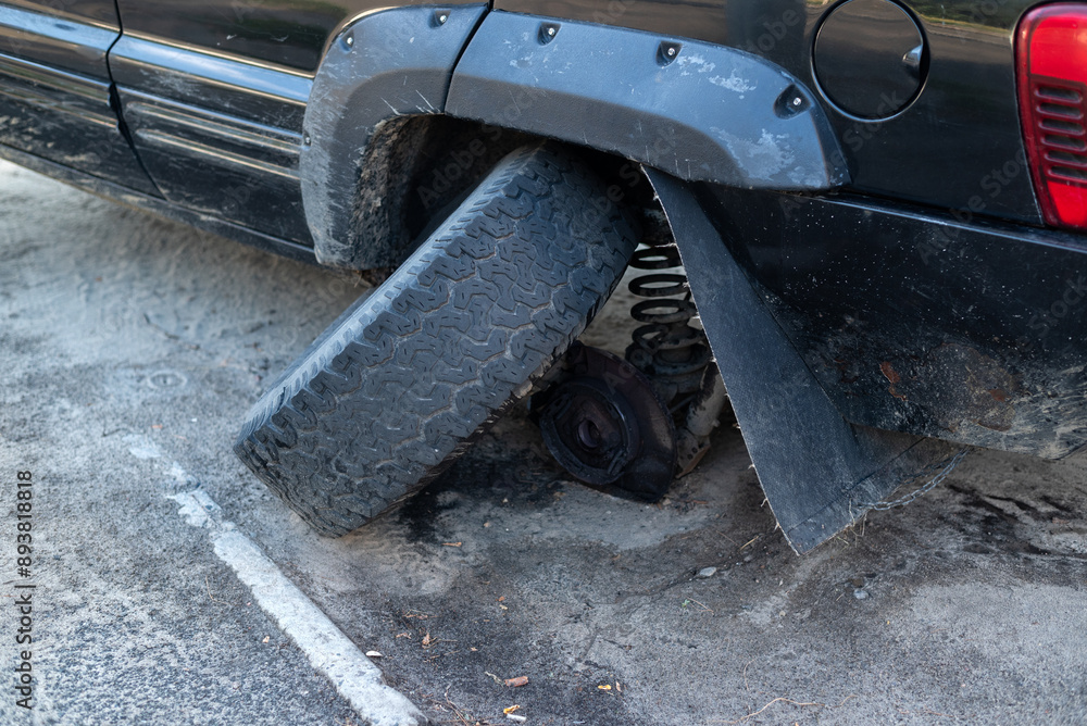 Broken Car Wheel on a Parked Vehicle close-up Broken Car Wheel on a Parked Vehicle close-up