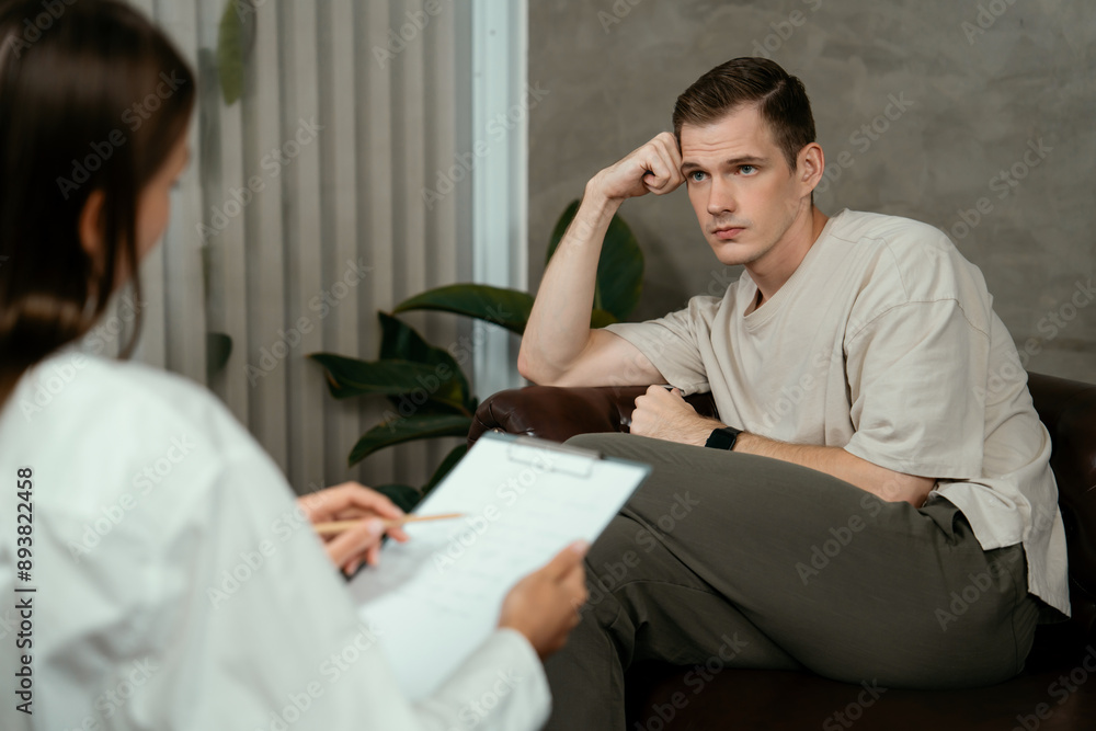 Stressed and depressed patient seeking help from psychiatrist with mental illness and depression in office during mental therapy session. Mental health treatment and medical care concept. Unveiling Stressed and depressed patient seeking help from psychiatrist with mental illness and depression in office during mental therapy session. Mental health treatment and medical care concept. Unveiling