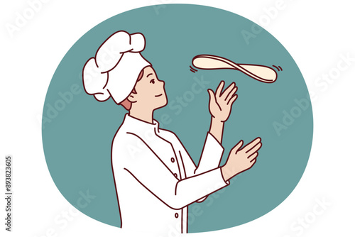 Man chef prepares pizza by tossing dough in open kitchen restaurant with traditional italian food. Guy in chef hat works in pizzeria and cook pizza according to classic old recipe.