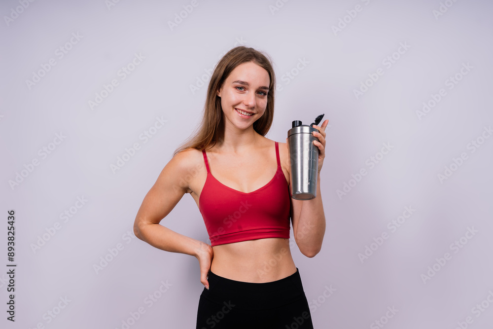 Closeup side view of sportive female after training who drinking fresh water from sport bottle Closeup side view of sportive female after training who drinking fresh water from sport bottle