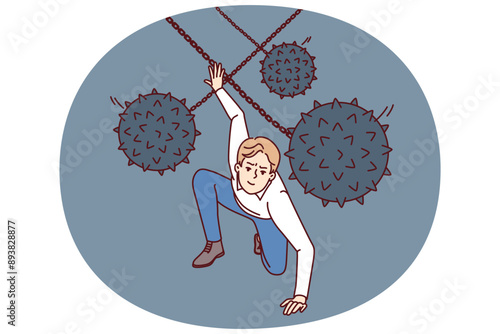 Brave man dodges prickly balls suspended from chain, symbolizing business problems and obstacles to success. Guy demonstrates leadership qualities by overcoming problems and adapting to situation