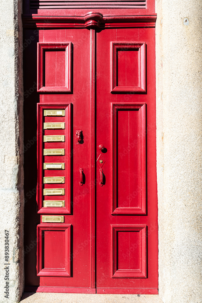 Old red door with golden mailboxes, Oporto, Portugal