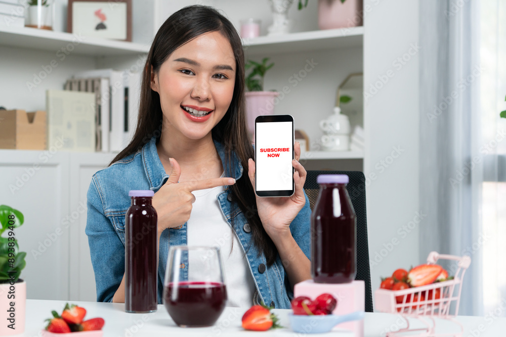 Smiling young beautiful Asian reviewing tasty mixed strawberry and cherry juice detox drinks, showing healthy product to promote for special promotion selling on social media online record. Stratagem. Smiling young beautiful Asian reviewing tasty mixed strawberry and cherry juice detox drinks, showing healthy product to promote for special promotion selling on social media online record. Stratagem.