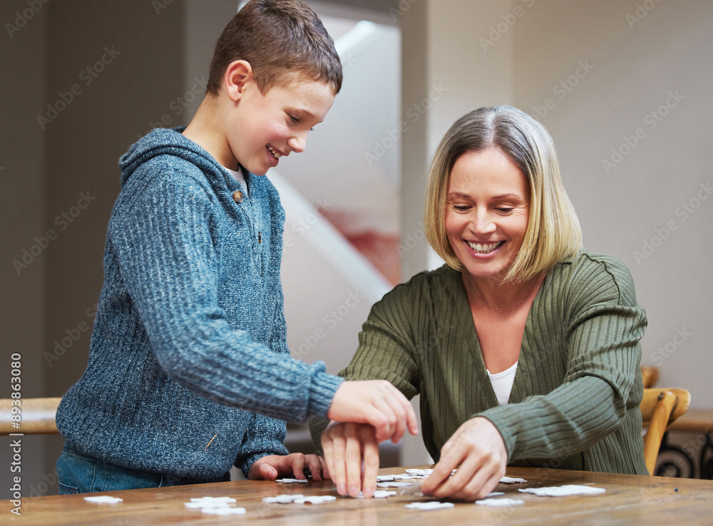 Fototapeta premium Happy, woman and kid with puzzle by table at home for development, support and problem solving. Family, mother and son with memory game in living room for cognitive, learning and growth in logic