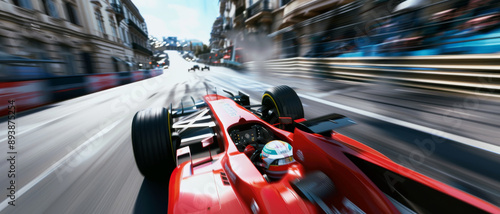 A powerful red race car speeds through a city street circuit, with scenery blurring by, showcasing the intense motion of racing.