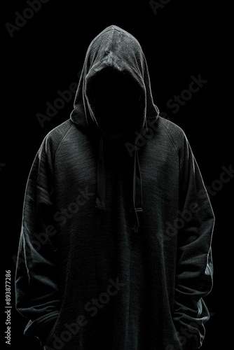 The silhouette of a hooded figure creates an air of mystery.