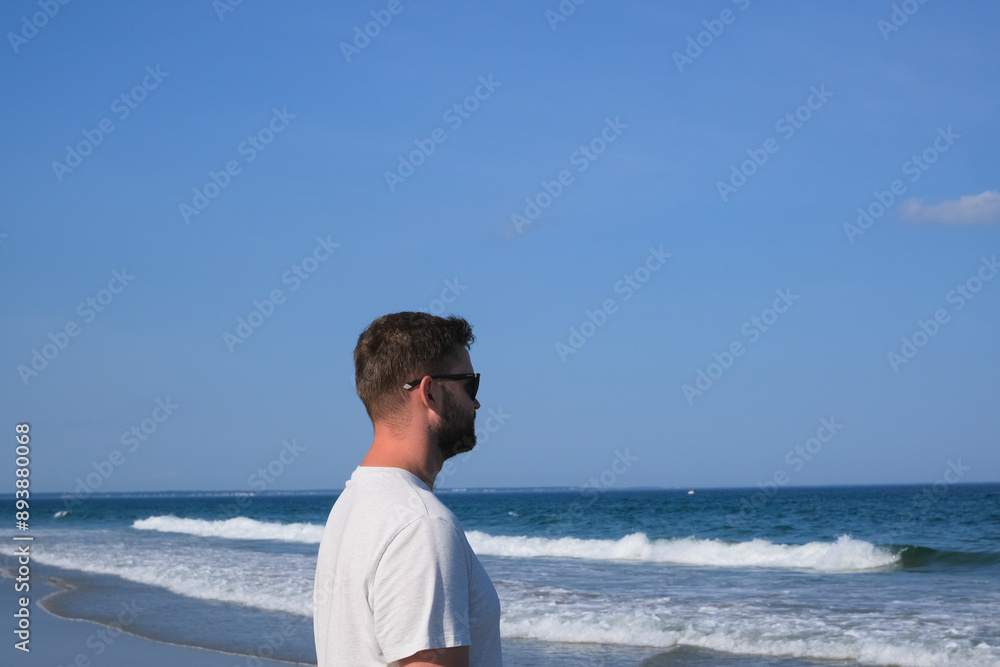 man walking on the beach, looking at the waves and blue sky, summer vacation mood, nature power man walking on the beach, looking at the waves and blue sky, summer vacation mood, nature power