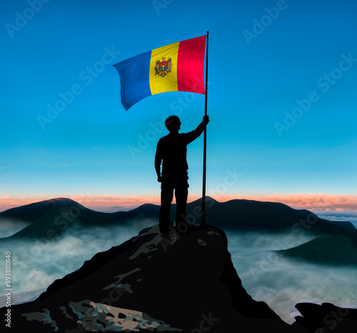 FLAG OF MOLDOVA ON THE TOP OF A MOUNTAIN CONQUERING SUCCESS