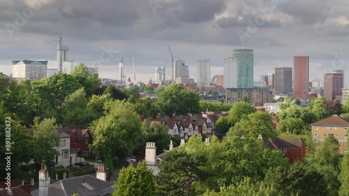 Birmingham city centre skyline 2024.
Evening summer sun shines on the towers and cranes of Birmingham City centre and trees in Edgbaston.  photo