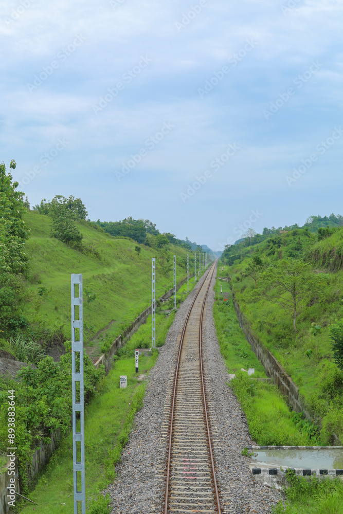 The railway line lies between the two hills The railway line lies between the two hills