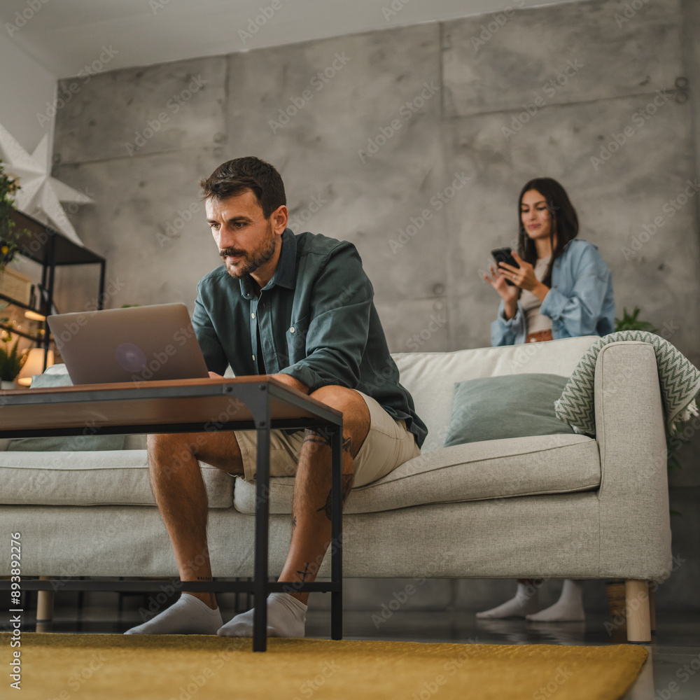 Adult caucasian man work from home and use laptop and papers Adult caucasian man work from home and use laptop and papers