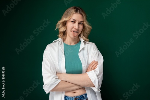 Woman With Arms Crossed Standing in Front of Green Background photo