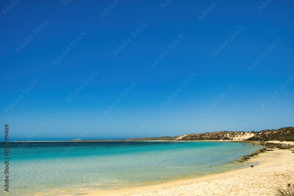 The crescent tropical beach at the holiday resort of Coral Bay, on the Coral Coast of Western Australia. A popular destination for snorkelling
The crescent tropical beach at the holiday resort of Coral Bay, on the Coral Coast of Western Australia. A popular destination for snorkelling