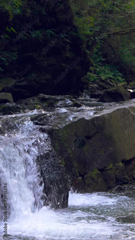 a small waterfall on a mountain river
a small waterfall on a mountain river