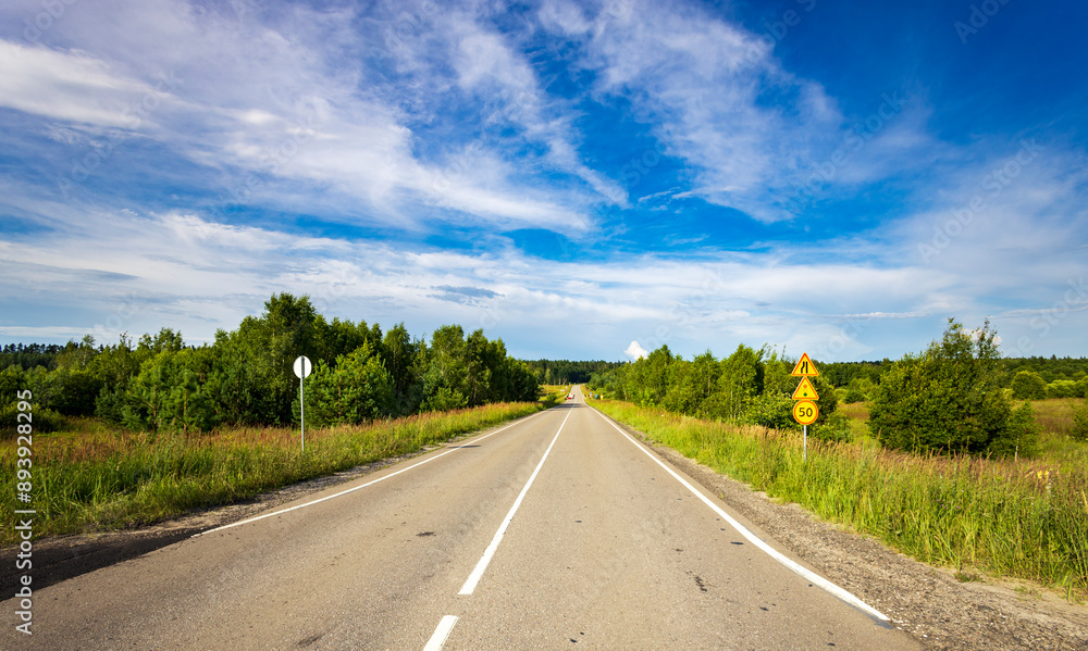 Fototapeta premium A road with a yellow sign on the side