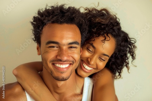 A man and a woman share a moment of joy as they smile together in harmony