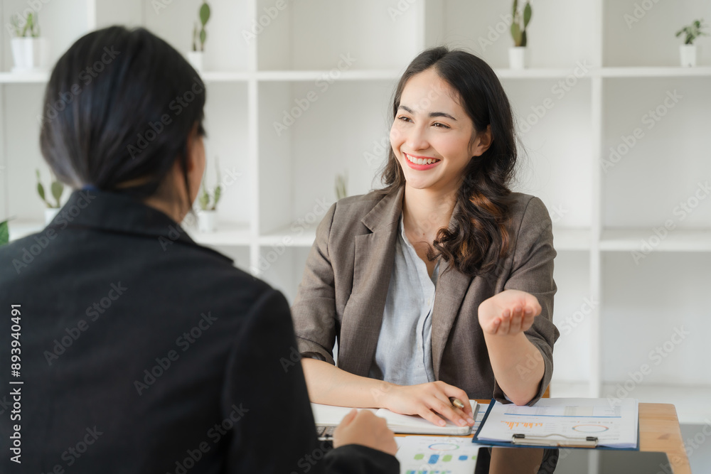 Asian people working together in an office environment It features women and business people working together. Asian people working together in an office environment It features women and business people working together.
