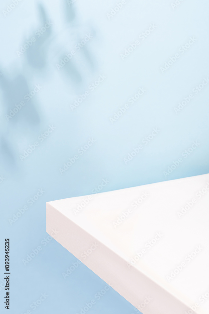 White podium for product presentation, on a blue background with beautiful shadows. Colorful summer background for product presentation White podium for product presentation, on a blue background with beautiful shadows. Colorful summer background for product presentation