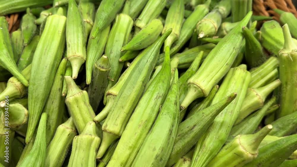 Fresh okra piled in a wicker basket at a market. Fresh okra piled in a wicker basket at a market.
