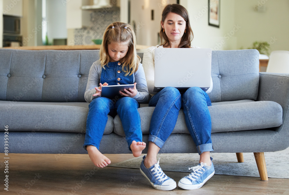 Laptop, tablet and mom with girl child in home for streaming movies, film or series together on sofa. Family, single parent or girl child with mom on technology for remote work, games or freelance Laptop, tablet and mom with girl child in home for streaming movies, film or series together on sofa. Family, single parent or girl child with mom on technology for remote work, games or freelance