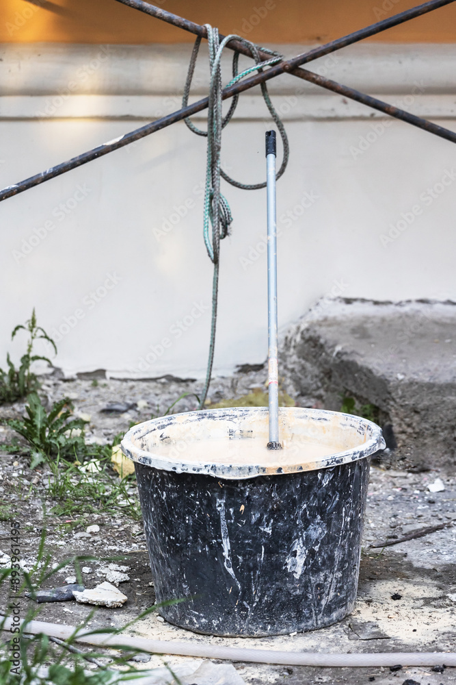 bucket of paint, whitewash, plaster on the street. bucket of paint, whitewash, plaster on the street.