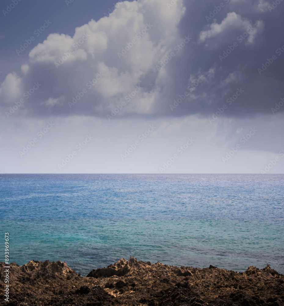 View of the turquoise blue ocean horizon under the cloudy sky of la guajira colombia View of the turquoise blue ocean horizon under the cloudy sky of la guajira colombia